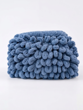 Blue plush cube-shaped pillow with a looped chenille texture.