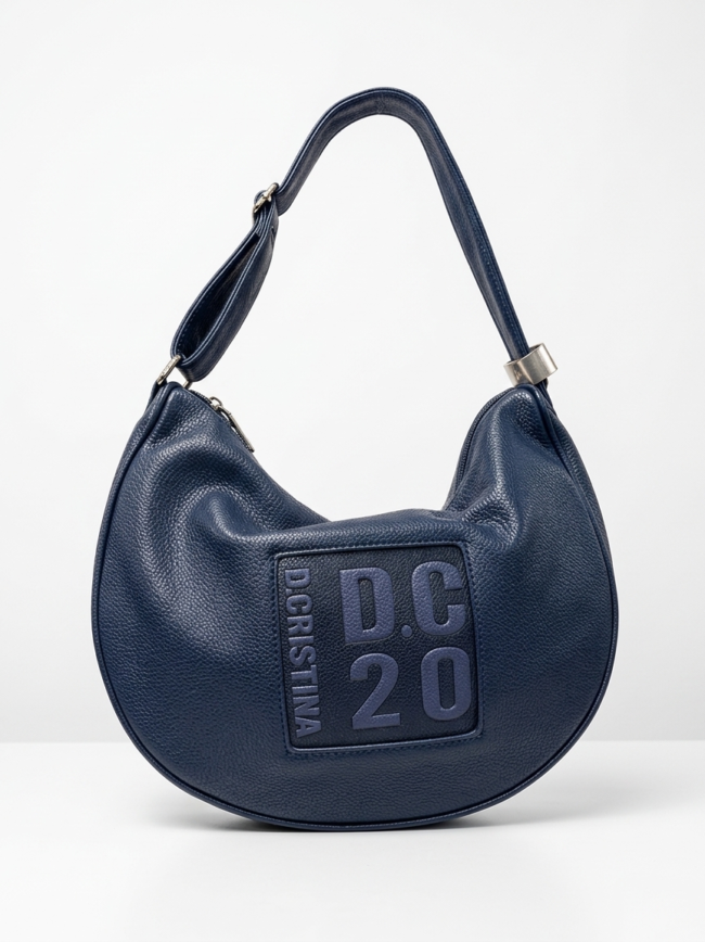 Navy blue pebbled leather shoulder bag with a curved handle and a square logo patch on the front.