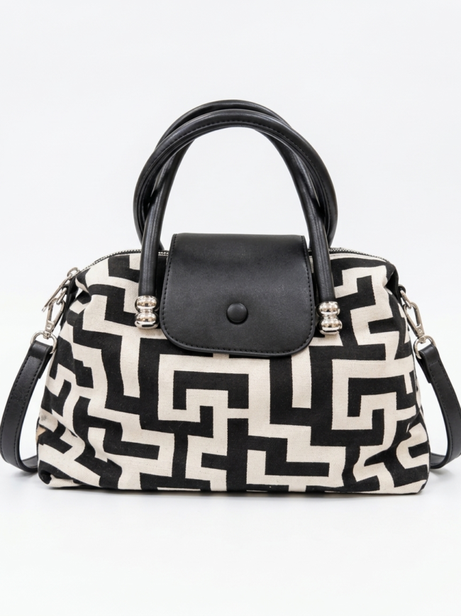 9HuLvsWQI-UdhH-3Yl0Oe1 Black-and-cream patterned handbag with black leather handles and a matching flap closure on a white background.