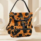 Leopard-print orange and black handbag with black strap and gold hardware, front zipper pocket visible.
