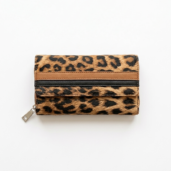 Leopard print wallet with a zipper and brown trim on a light background