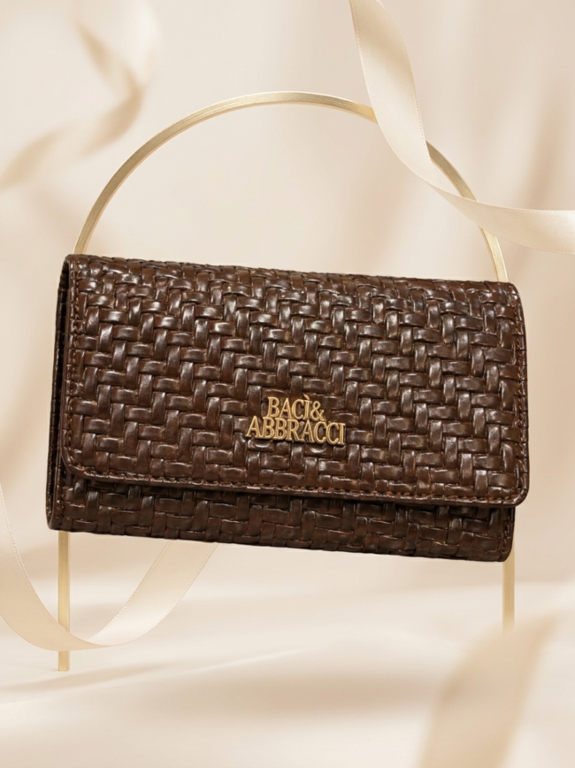 Brown woven leather handbag with gold Baci & Abbracci logo on a light backdrop.