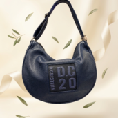 Dark blue leather hobo bag with a square patch reading 'DC20' on the front.