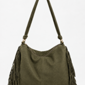 Olive green shoulder bag with long fringe on both sides and a padded strap, gold-tone hardware, curved zipper opening at the top.