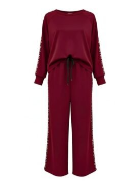 Maroon jumpsuit with long sleeves, drawstring at the waist, and white braided trim along the sleeves.