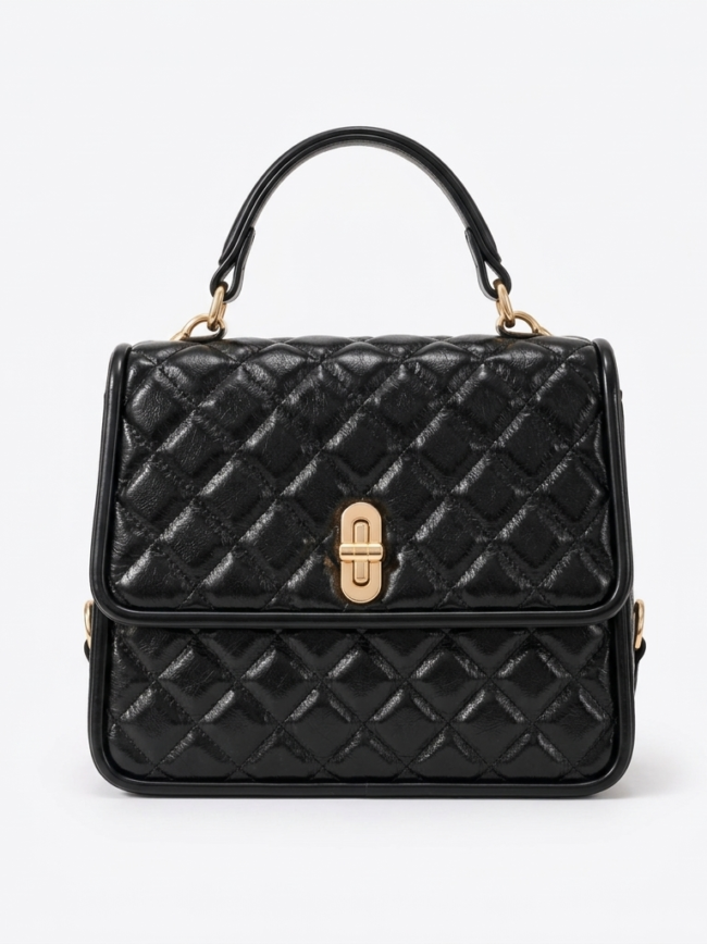 μαυρη τσαντα 3 Black quilted leather handbag with a gold-tone clasp and a top handle on a clean backdrop.