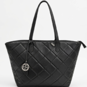 Black quilted tote bag with double handles and a circular metal charm hanging from one handle.
