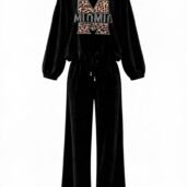 Black velour two-piece tracksuit (sweatshirt and wide-leg pants) with a leopard-print large 'M' graphic on the front of the top. The top has gathered cuffs and a drawstring at the waist.