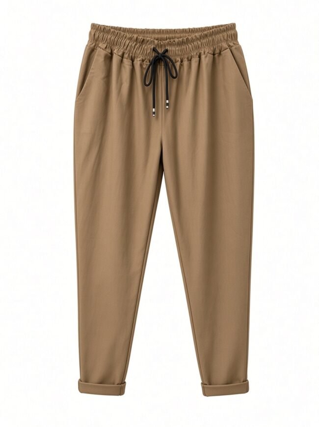 Tan jogger pants with an elastic waistband and black drawstring, relaxed fit, cuffs rolled up.